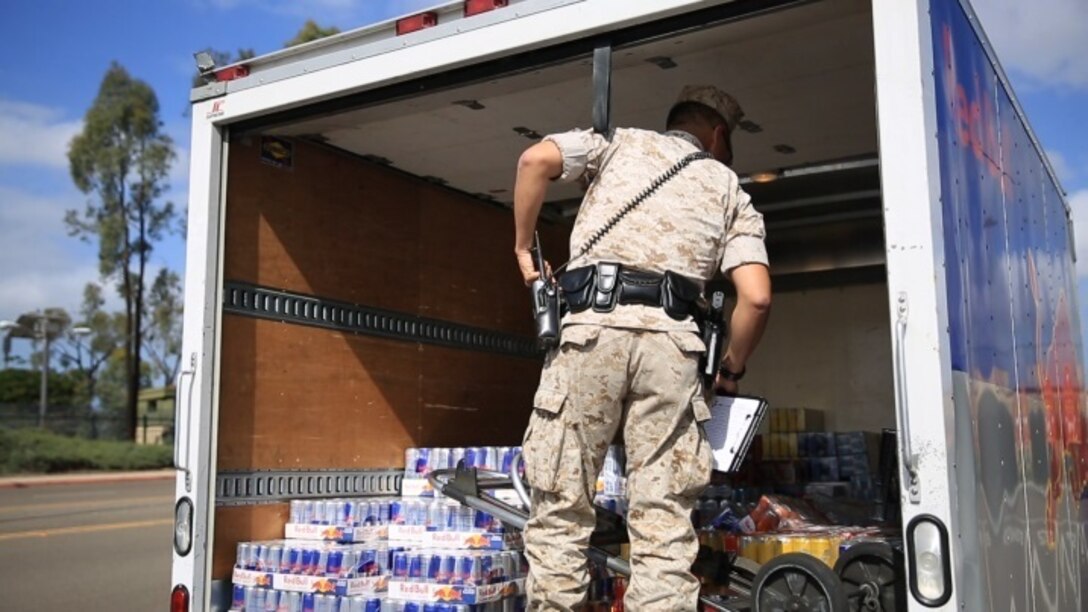 Cpl. Siheng Yang, a military police officer with the Provost Marshal’s Office, physically inspects a commercial vehicle for anything suspicious aboard Marine Corps Air Station Miramar, Calif., March 22. Inspecting vehicles is important to provide safety and security to those on the installation, according to Yang. (U.S. Marine Corps photo by Sgt. Michael Thorn/Released)