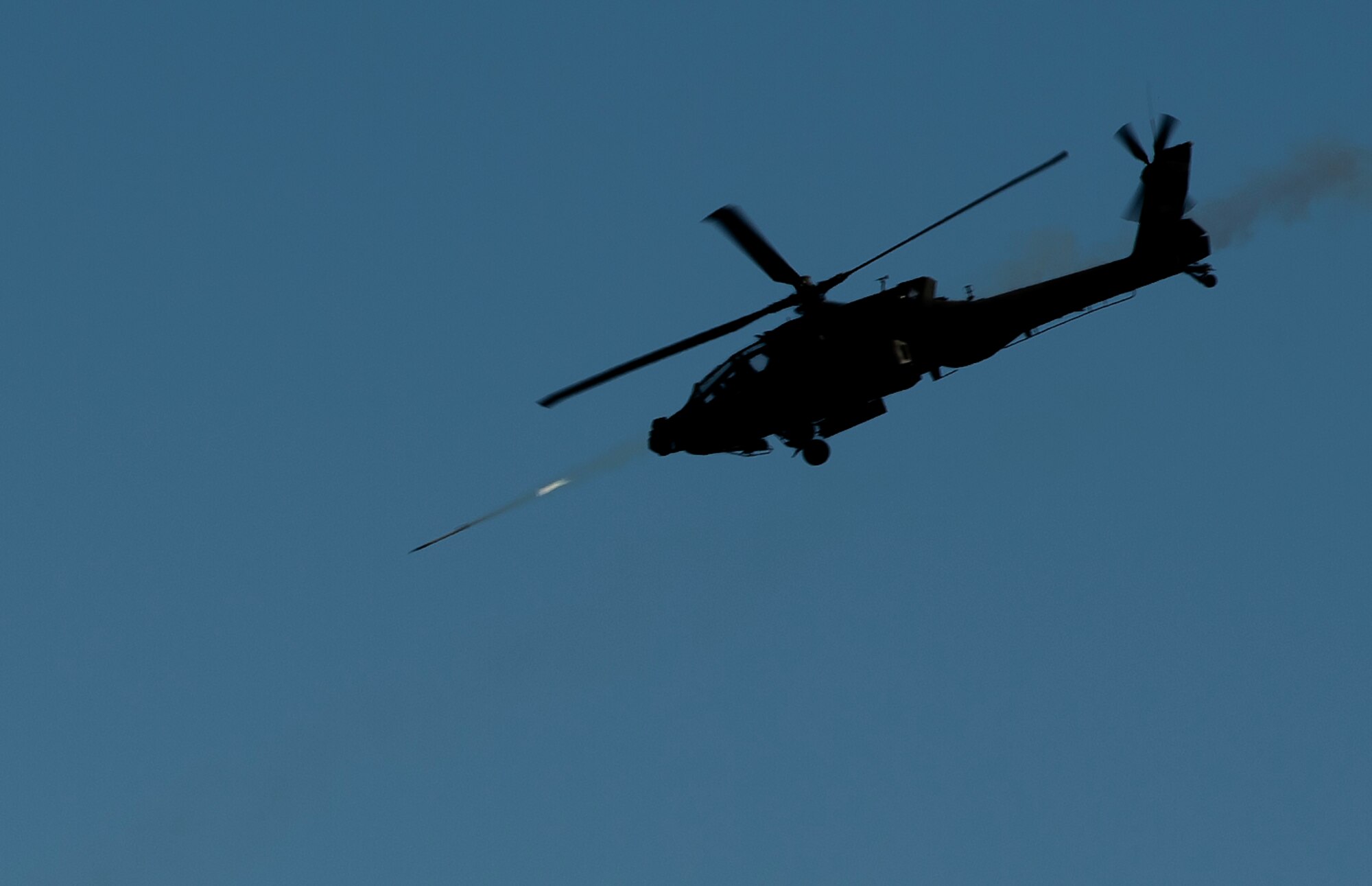 A U.S. Army AH-64 Apache D, shoots a missile over Eglin Range, Fla., during close air support training during Emerald Warrior 16, May 11, 2016. Emerald Warrior is a U.S. Special Operations Command-sponsored mission rehearsal exercise during which joint special operations forces train to respond to real and emerging worldwide threats. (U.S. Air Force photo by Senior Airman Trevor T. McBride)        