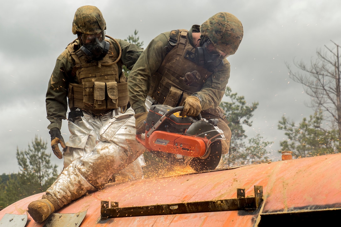 Marine Corps Lance Cpl. Kingston Baker-Griffin saws through the roof of a simulated aircraft as part of the aircraft salvage and recovery operations during exercise Thunder Horse 16.2 at the Japan Ground Self-Defense Force’s Haramura Maneuver Area in Hiroshima, Japan, May 11, 2016. Marine Corps photo by Lance Cpl. Aaron Henson