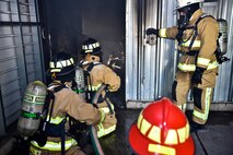 932nd Airlift Wing Civil Engineer Squadron firefighters feel the heat of a class A fire with temperatures exceeding 600 degrees fahrenheit during live fire training for structural fires May 14, 2016, Scott Air Force Base, Illinois.  (U.S. Air Force photo by Tech. Sgt. Christopher Parr)