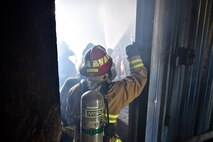 932nd Airlift Wing Civil Engineer Squadron firefighters feel the heat of a class A fire with temperatures exceeding 600 degrees fahrenheit during live fire training for structural fires May 14, 2016, Scott Air Force Base, Illinois.  (U.S. Air Force photo by Tech. Sgt. Christopher Parr)