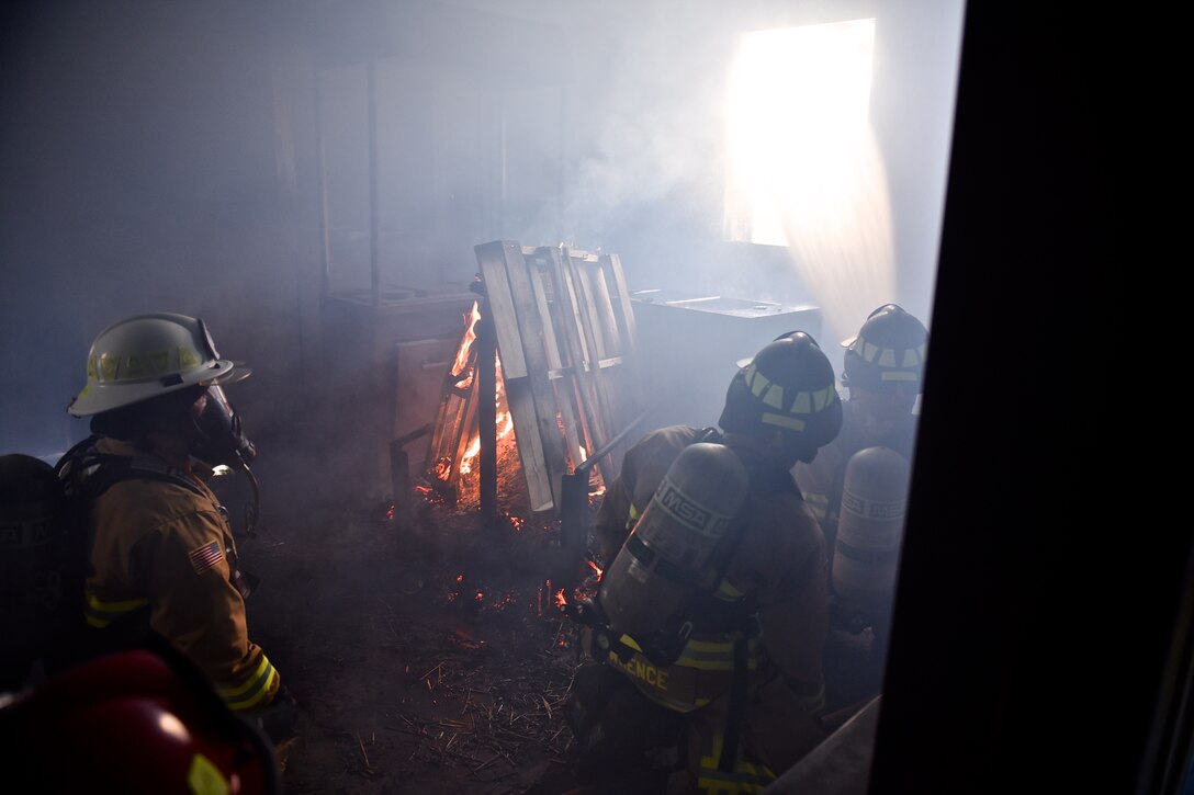 932nd Airlift Wing Civil Engineer Squadron firefighters feel the heat of a class A fire with temperatures exceeding 600 degrees fahrenheit during live fire training for structural fires May 14, 2016, Scott Air Force Base, Illinois.  (U.S. Air Force photo by Tech. Sgt. Christopher Parr)
