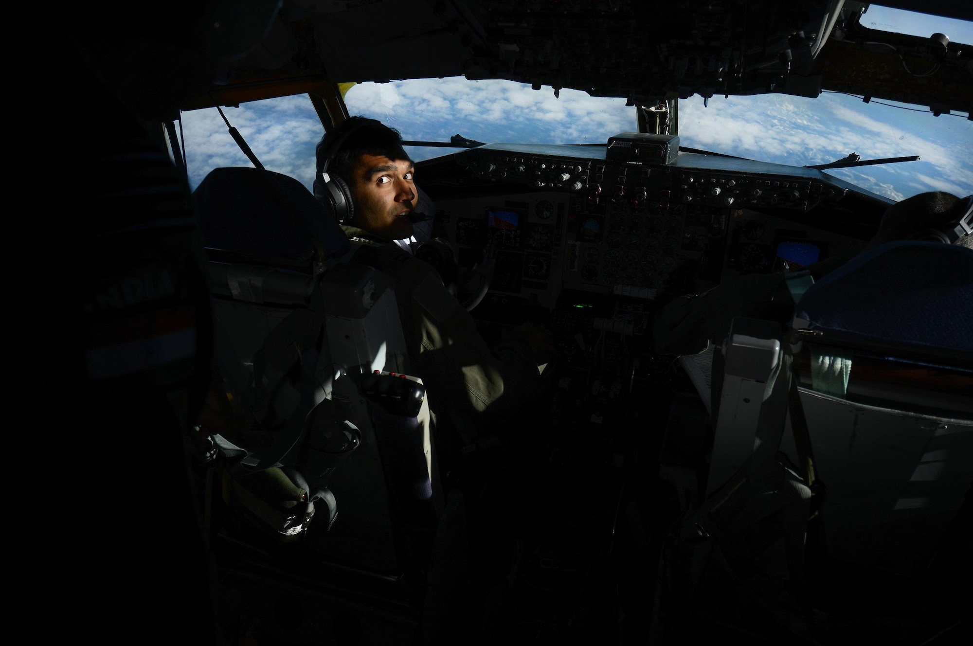 U.S. Air Force Capt. Karan Bansal, a KC-135 Stratotanker pilot assigned to the 909th Air Refueling Squadron, Kadena Air Base, Japan, directs his attention to an Indian Air Force airman, May 12, 2016, over the Joint Pacific Alaska Range Complex. As part of RED FLAG-Alaska 16-1, the 67th Fighter Squadron, 80th FS and the 909th ARS conducted an in-flight refueling exercise to demonstrate how tanker support can extend and prolong flight operations for U.S. and coalition aircraft. (U.S. Air Force photo by Tech. Sgt. Steven R. Doty)