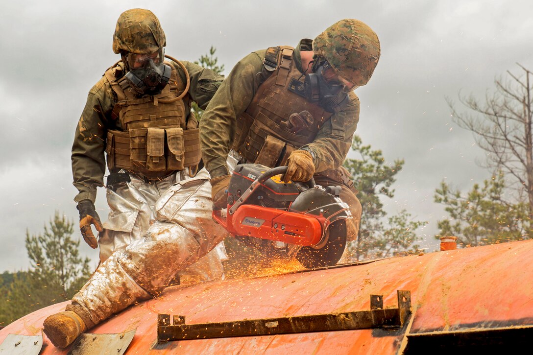 Marine Corps Lance Cpl. Kingston Baker-Griffin saws through the roof of a simulated aircraft as part of the aircraft salvage and recovery operations during exercise Thunder Horse 16.2 at the Japan Ground Self-Defense Force’s Haramura Maneuver Area in Hiroshima, Japan, May 11, 2016. Marine Corps photo by Lance Cpl. Aaron Henson