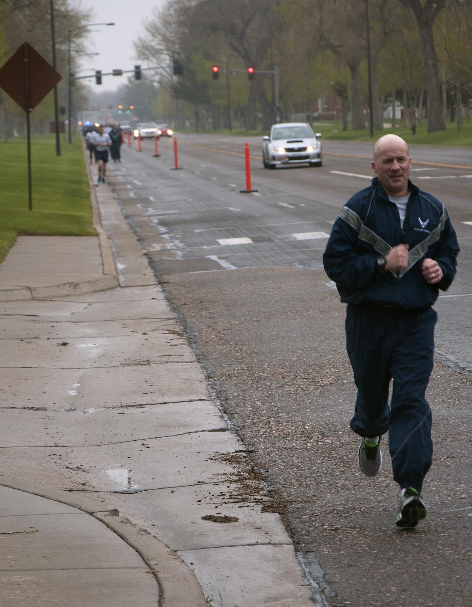 Col. Christopher Corley, 90th Security Forces Group commander, runs down Randall Avenue on F.E. Warren Air Force Base, Wyo., May 16, 2016, during a memorial 5-kilometer ruck-run in honor of National Police Week. Police week is a day of remembrance for those who are gone and to honor those who continue to serve as police officers. (U.S. Air Force photo by Senior Airman Brandon Valle)