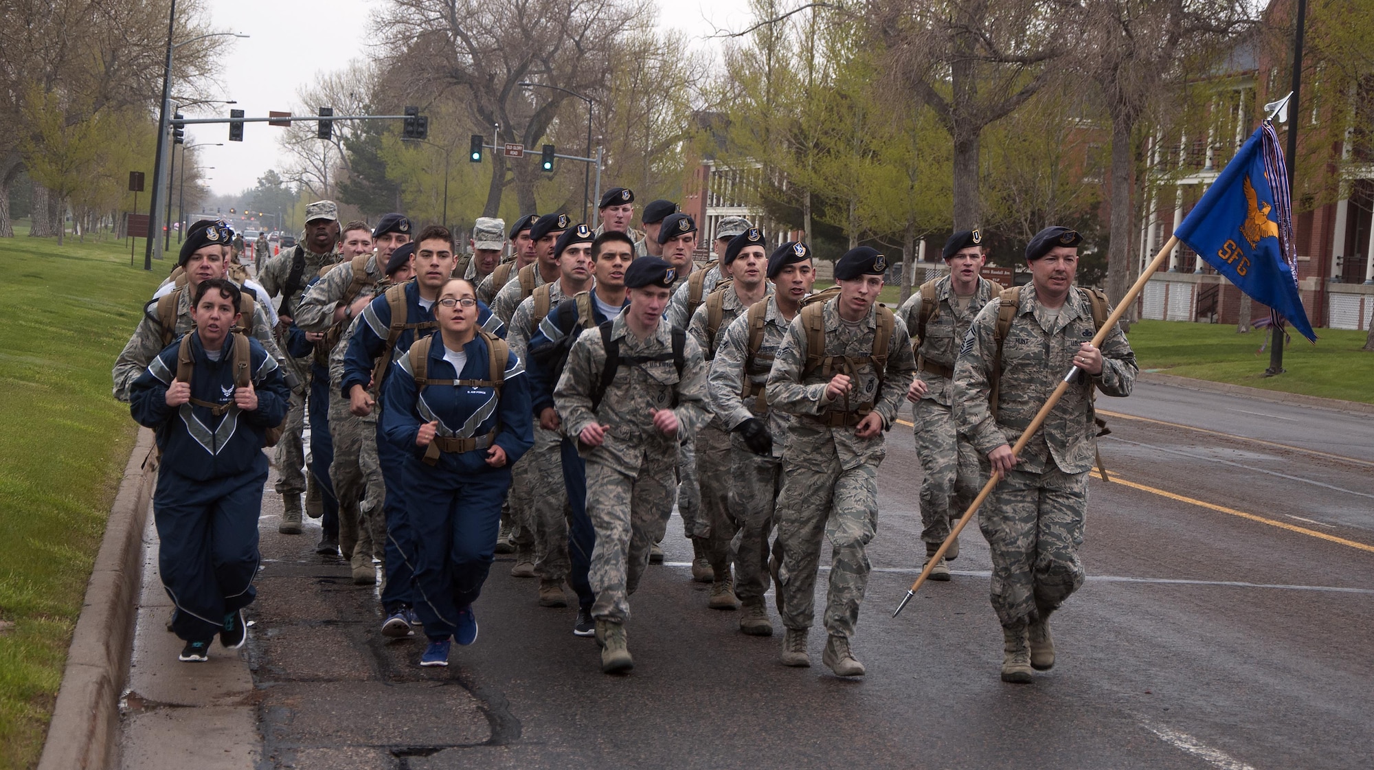 Ninetieth Security Forces Group defenders march in formation down Randall Ave. on F.E. Warren Air Force Base, Wyo., May 16, 2016, during a memorial 5-kilometer ruck-run in honor of National Police Week. Half of the defenders marched in the formation while the other half ran or walked the course. (U.S. Air Force photo by Senior Airman Brandon Valle)