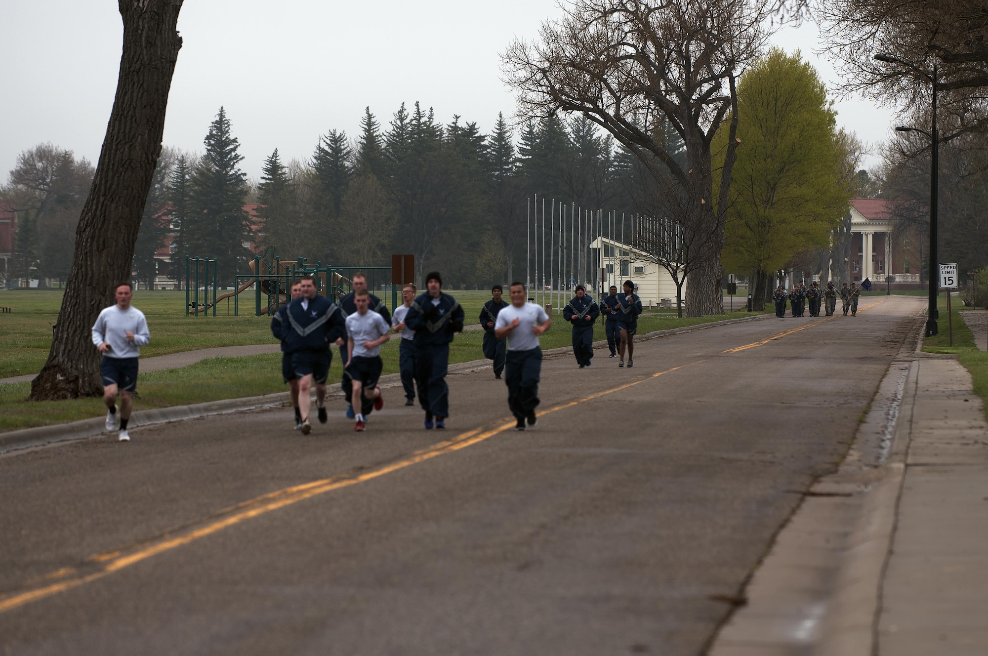 Ninetieth Security Forces Group defenders run and march down Fort Warren Ave. on F.E. Warren Air Force Base, Wyo., May 16, 2016, during a memorial 5-kilometer ruck-run in honor of National Police Week. The 5K was the first of four events planned by the 90th SFG to remember and honor those who serve as police as civilians and in the military. (U.S. Air Force photo by Senior Airman Brandon Valle)