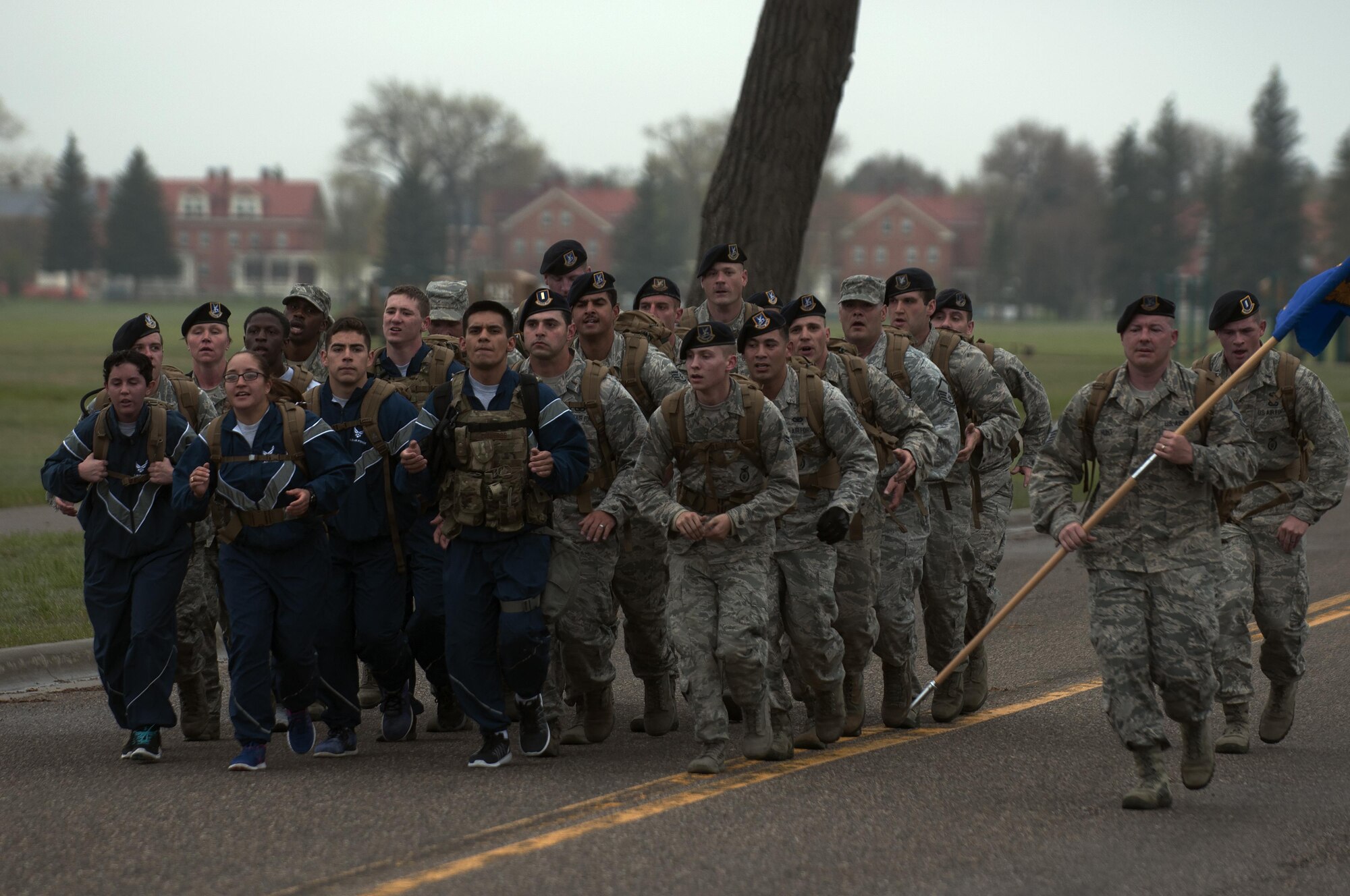 Ninetieth Security Forces Group defenders march in a formation down Fort Warren Ave. on F.E. Warren Air Force Base, Wyo., May 16, 2016, during a memorial 5-kilometer ruck-run in honor of National Police Week. Police Week is a day of remembrance for those who have passed and to honor those who continue to serve as police officers. (U.S. Air Force photo by Senior Airman Brandon Valle)