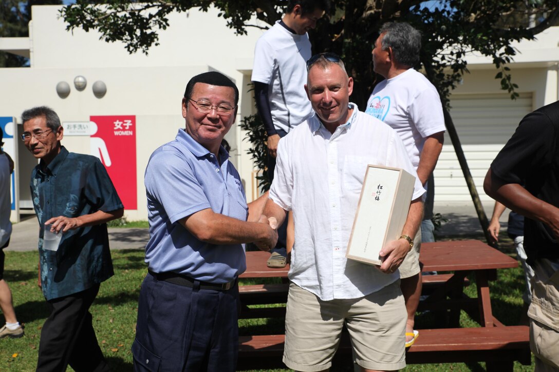 Hajime Nakama, the Kin Mayor, shakes hands with Col. Sean McBride, the commanding officer of III Marine Headquarters Group May 14 at the Nature Mirai in Kin Town. McBride joined Nakama for a BBQ and Yakosoba lunch. The two discussed the good relationships between the local community and service members in Kin Town. 