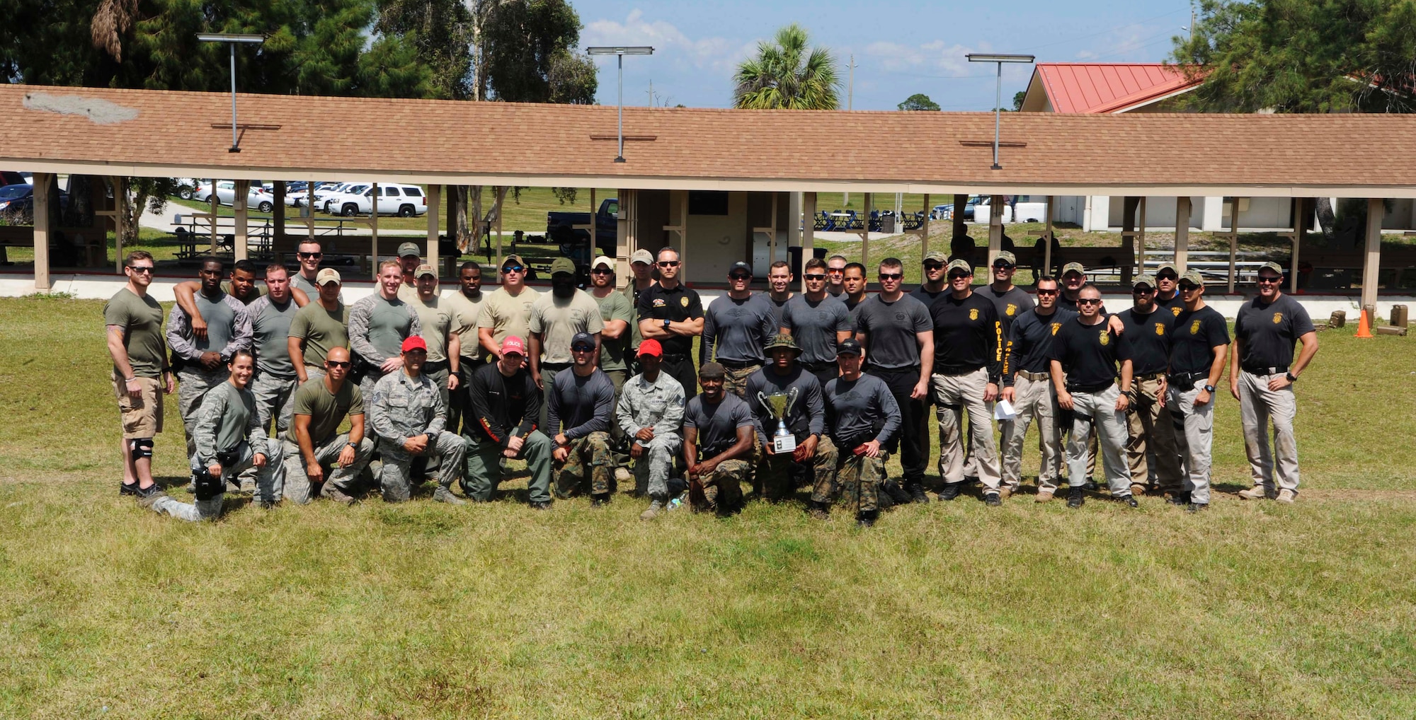Members from the 6th Security Forces Squadron emergency services team and local police forces pose for a group photo, May 13, 2016 at MacDill Air Force Base, Fla. The teams came together to participate in the third annual tactical competition for National Police Week. (U.S. Air Force photo by Airman Adam R. Shanks)