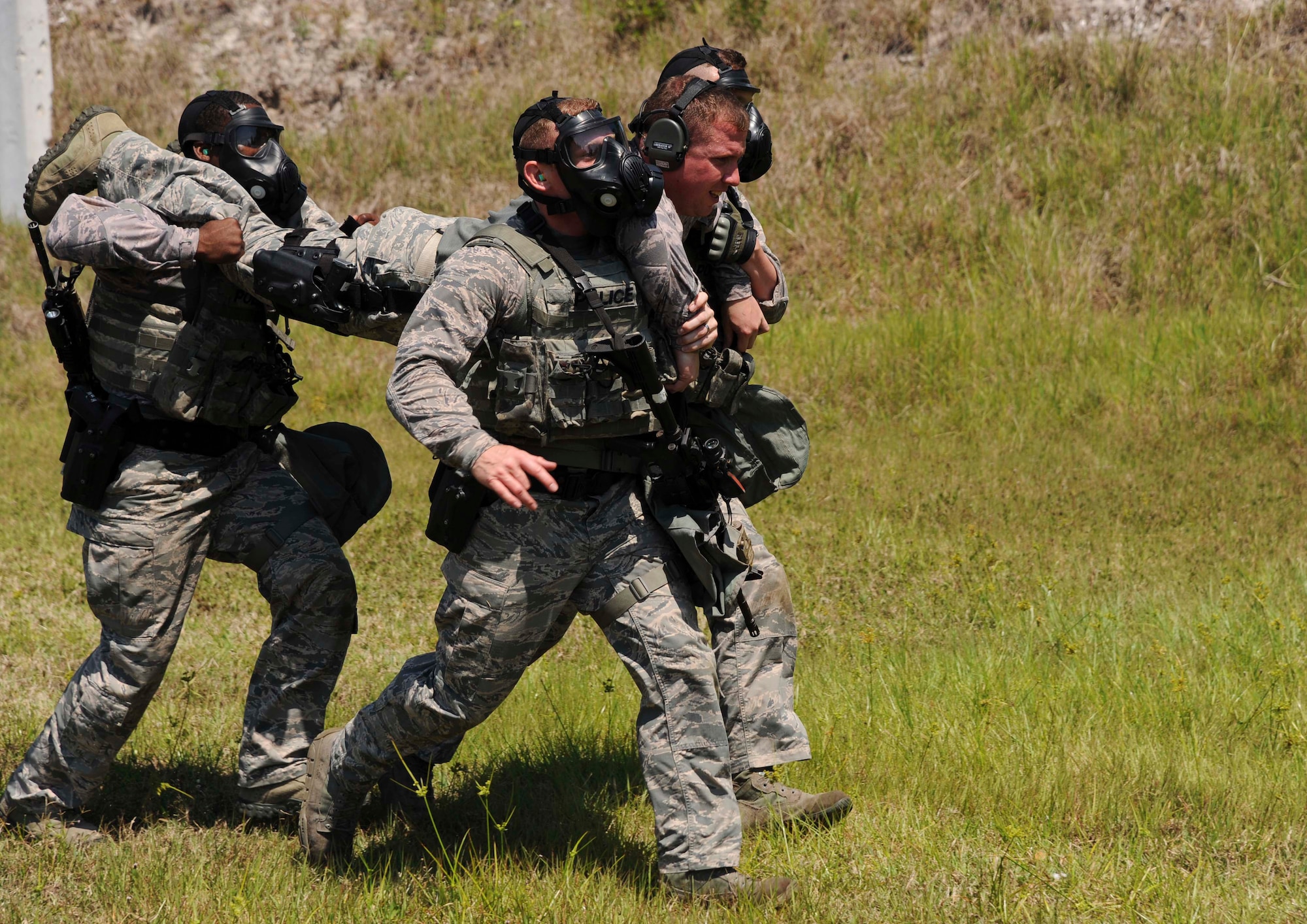 Members from the 6th Security Forces Squadron emergency services team carry a “downed officer” for a scenario during the third annual tactical competition, May 13, 2016 at MacDill Air Force Base, Fla. Local police forces also participated in the competition for National Police Week. (U.S. Air Force photo by Airman Adam R. Shanks)