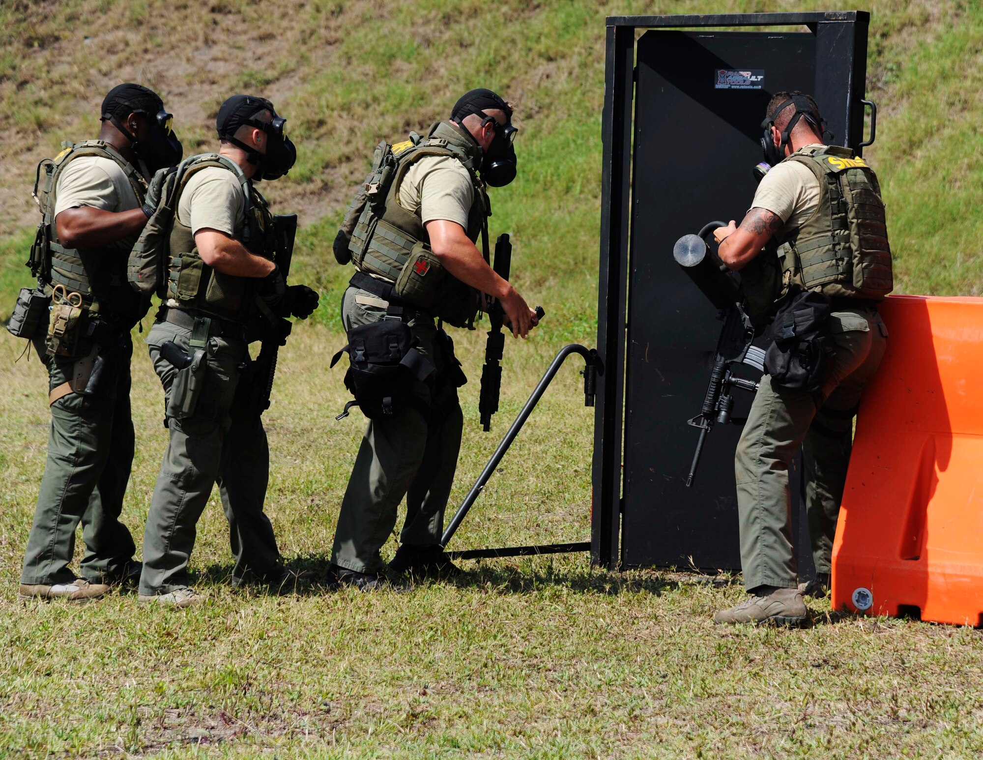 Officers from the Pinellas County Sheriff’s Office special weapons and tactics team breach a door to throw in a flashbang, May 13, 2016 at MacDill Air Force Base, Fla. The door breach was a part of the third annual tactical competition hosted by the 6th Security Forces Squadron. (U.S. Air Force photo by Airman Adam R. Shanks)