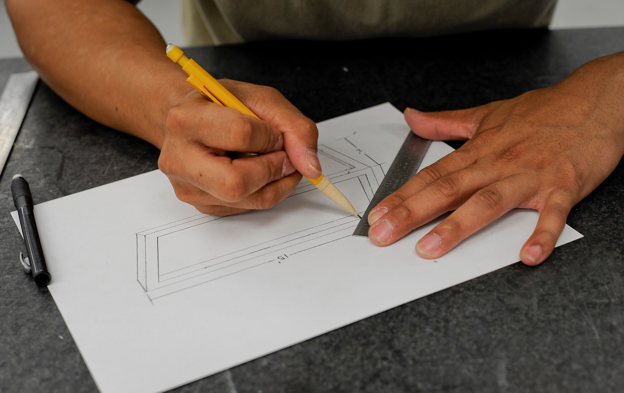 Staff Sgt. Armand Guting, an aircraft metals technology technician with the 6th Maintenance Squadron, draws a blueprint for a customized paint rack at MacDill Air Force Base, Fla., May 13, 2016. Once the blueprint has been drafted, it will be confirmed with the corrosion facility. (U.S. Air Force photo by Airman 1st Class Mariette Adams)