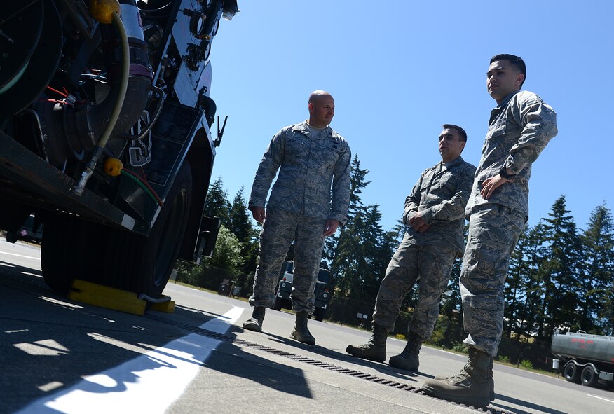 Capt. Jason Henry (left), 627th Logistics Readiness Squadron operations officer, learns about the different functions of the R-12 hydrant refueling vehicle from Senior Airman Matthew Bradley (middle), 627th LRS fuels service controller, and Airman 1st Class Tyler Marsh (right), 627th LRS fuel laboratory technician, May 12, 2016 at Joint Base Lewis-McChord, Wash. Knowing he wanted to lead Airmen by example, Henry commissioned in 2006 after serving as an enlisted member for 11 years in the Air Force. (U.S. Air Force photo/Senior Airman Divine Cox)