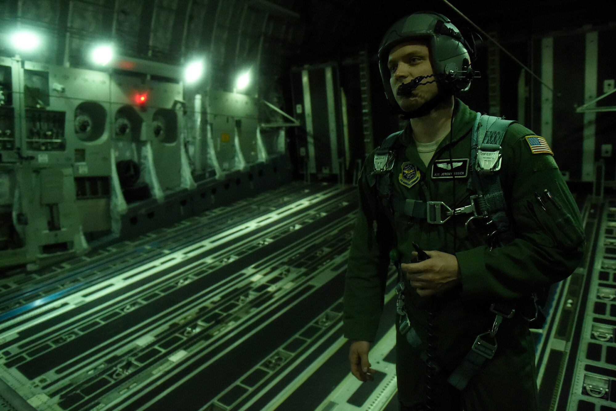 Airman 1st Class Jeremy Kosick, 8th Airlift Squadron loadmaster, prepares to open the doors of a C-17 Globemaster III, so paratroopers from the 82nd Airborne Division can conduct a static line jump during an exercise May 3, 2016 over Texas. This exercise was sponsored by United States Special Operations Command and was a Joint National Training Capability accredited exercise program.  (U.S. Air Force photo/ Tech. Sgt. Tim Chacon) 