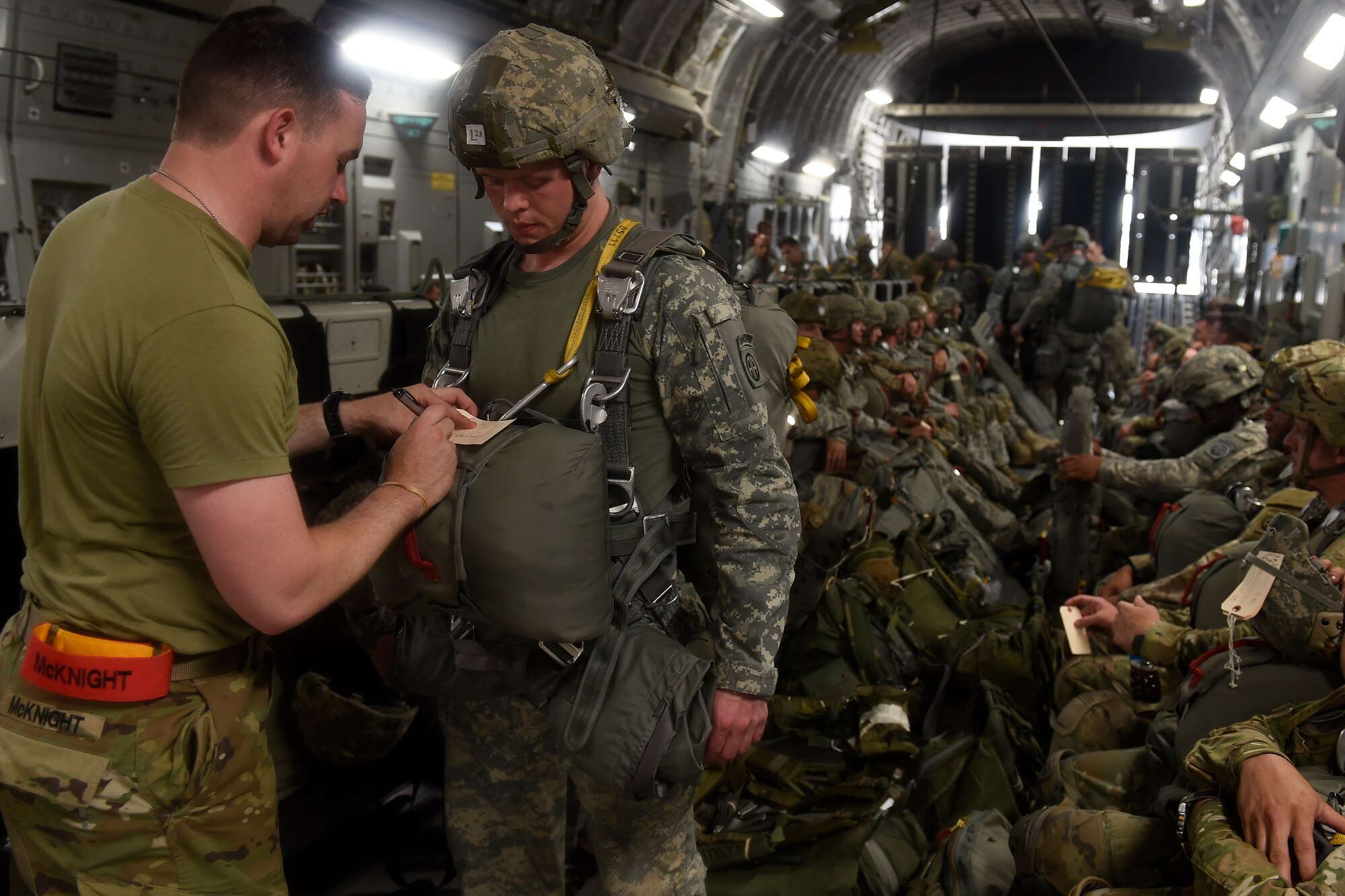Paratroopers from the 82nd Airborne Division prepare their parachutes May 3, 2016 at Pope Army Airfield, N.C. for a static line jump during a training exercise. The units involved in the exercise trained in: infiltration and exfiltration of personnel and equipment, personnel recovery operations, integration of conventional forces, airborne operations, aerial resupply, long range movements and exercising command and control elements. (U.S. Air Force photo/ Tech. Sgt. Tim Chacon)