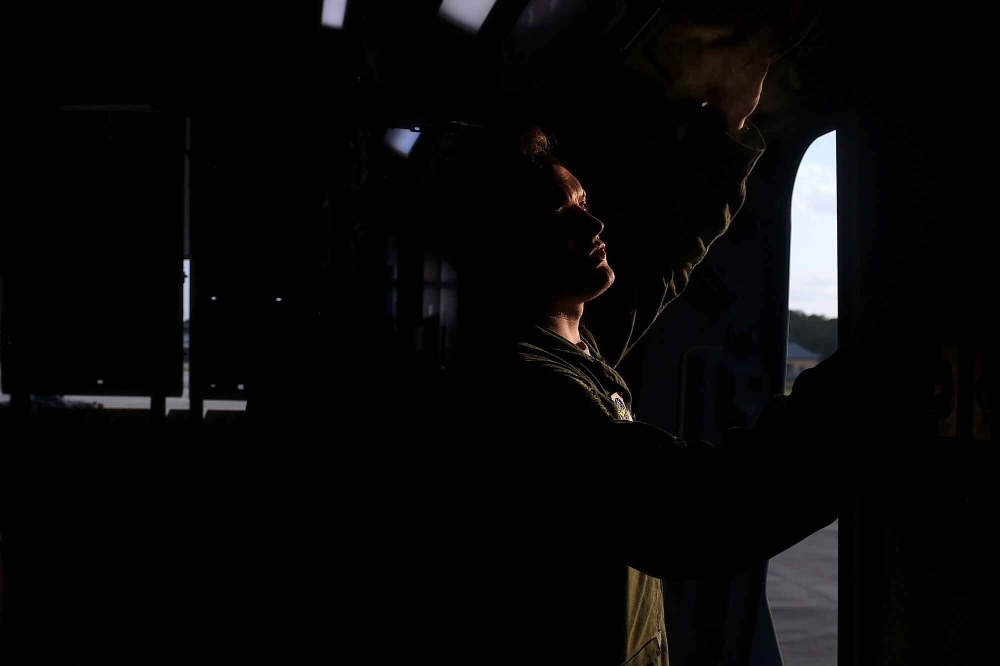 Airman 1st Class Jeremy Kosick, 8th Airlift Squadron loadmaster, prepares to open the doors of a C-17 Globemaster III, so paratroopers from the 82nd Airborne Division can conduct a static line jump during an exercise May 3, 2016 over Texas. This exercise was sponsored by United States Special Operations Command and was a Joint National Training Capability accredited exercise program.  (U.S. Air Force photo/ Tech. Sgt. Tim Chacon) 