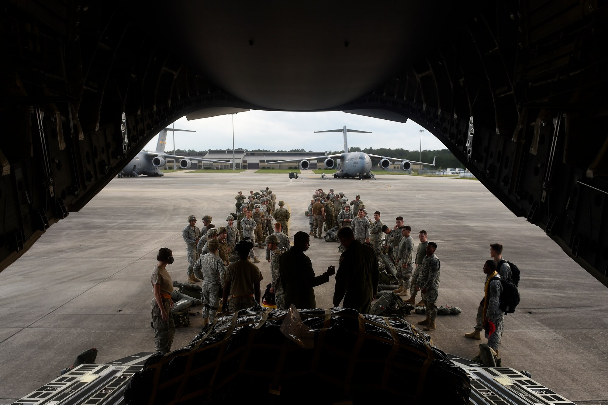 Paratroopers from the 82nd Airborne Division prepare to load onto a 62nd Airlift Wing C-17 Globemaster III May 3, 2016 at Pope Army Airfield, N.C. More than 350 paratroopers were inserted into the drop zone by C-17s and C-130 Hercules. (U.S. Air Force photo/ Tech. Sgt. Tim Chacon) 