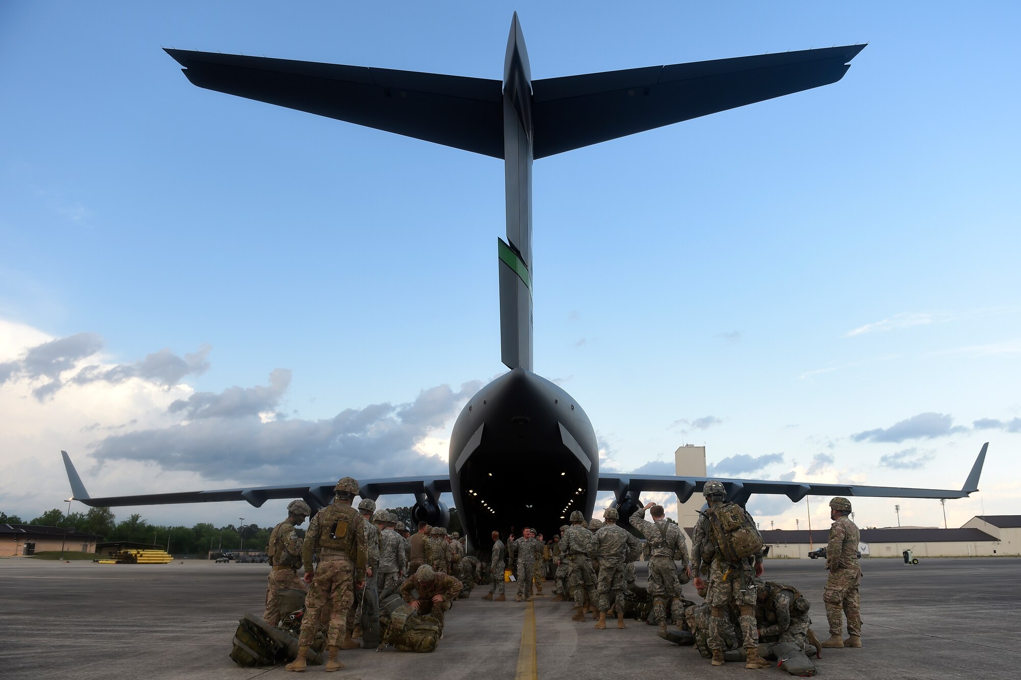 Paratroopers from the 82nd Airborne Division prepare to load onto a 62nd Airlift Wing C-17 Globemaster III May 3, 2016 at Pope Army Airfield, N.C. The paratroopers were simulating parachuting into a hostile airfield and seizing it to allow for follow on delivery of more troops and cargo. (U.S. Air Force photo/ Tech. Sgt. Tim Chacon) 