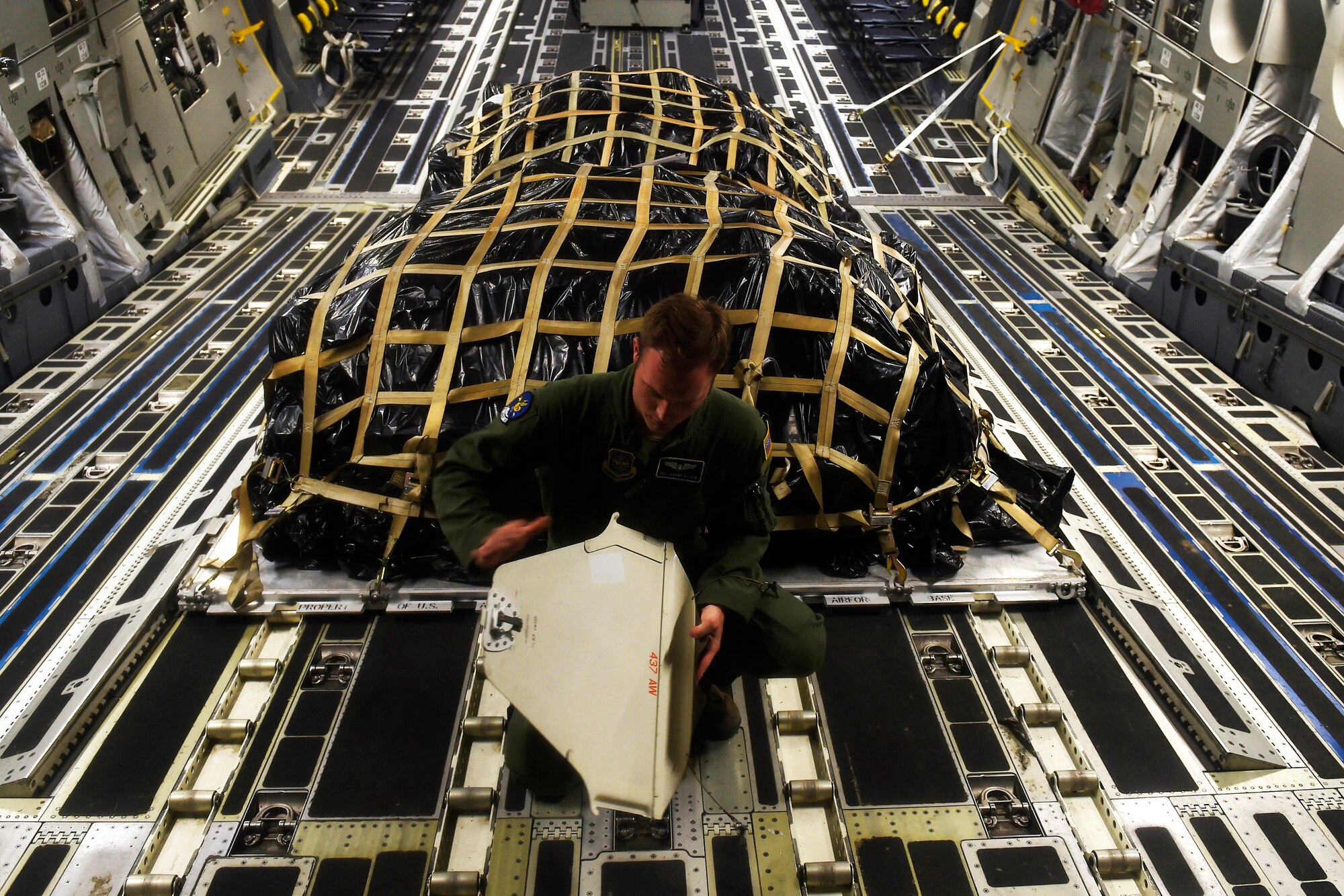 Airman 1st Class Jeremy Kosick, 8th Airlift Squadron loadmaster, prepares a C-17 Globemaster III for the arrival of 82nd Airborne Division paratroopers May 3, 2016 at Pope Army Airfield, N.C. Kosick and his crew dropped 60 paratroopers over a simulated enemy airfield in Texas. (U.S. Air Force photo/ Tech. Sgt. Tim Chacon)