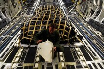 Airman 1st Class Jeremy Kosick, 8th Airlift Squadron loadmaster, prepares a C-17 Globemaster III for the arrival of 82nd Airborne Division paratroopers May 3, 2016 at Pope Army Airfield, N.C. Kosick and his crew dropped 60 paratroopers over a simulated enemy airfield in Texas. (U.S. Air Force photo/ Tech. Sgt. Tim Chacon)