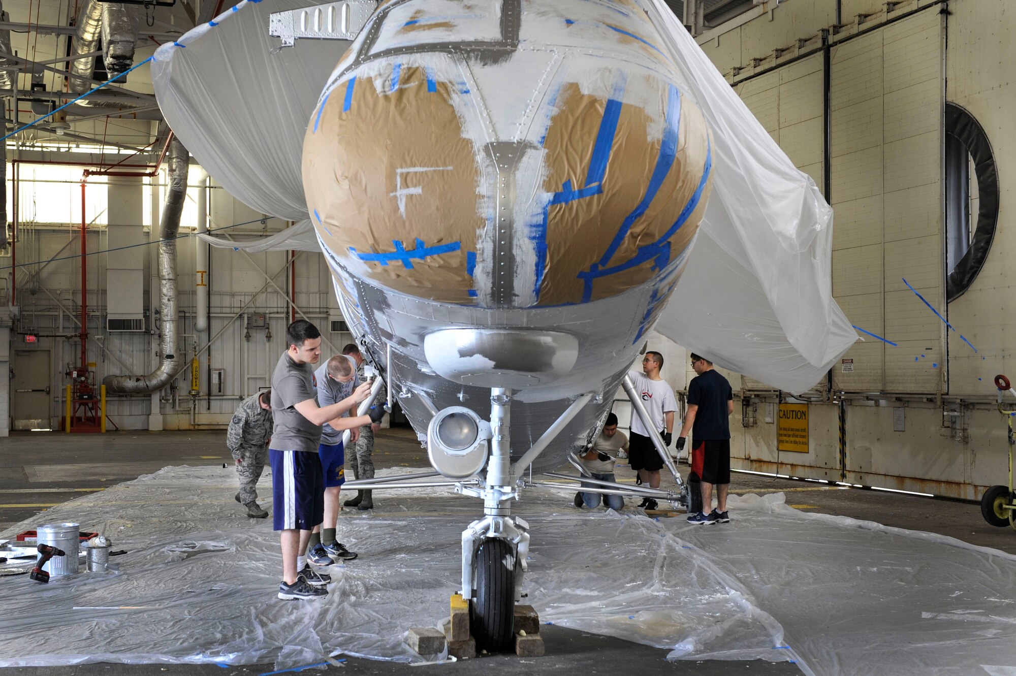 U.S. Air Force Airmen from the 314th Aircraft Maintenance Squadron paint a finishing coat on a Piasecki H-21 Workhorse helicopter May 12, 2015, at Little Rock Air Force Base, Ark. The 314th Airlift Wing received the helicopter from Kirtland Air Force Base and plan to display it in Heritage Park toward the end of June. (U.S. Air Force photo by Senior Airman Stephanie Serrano)