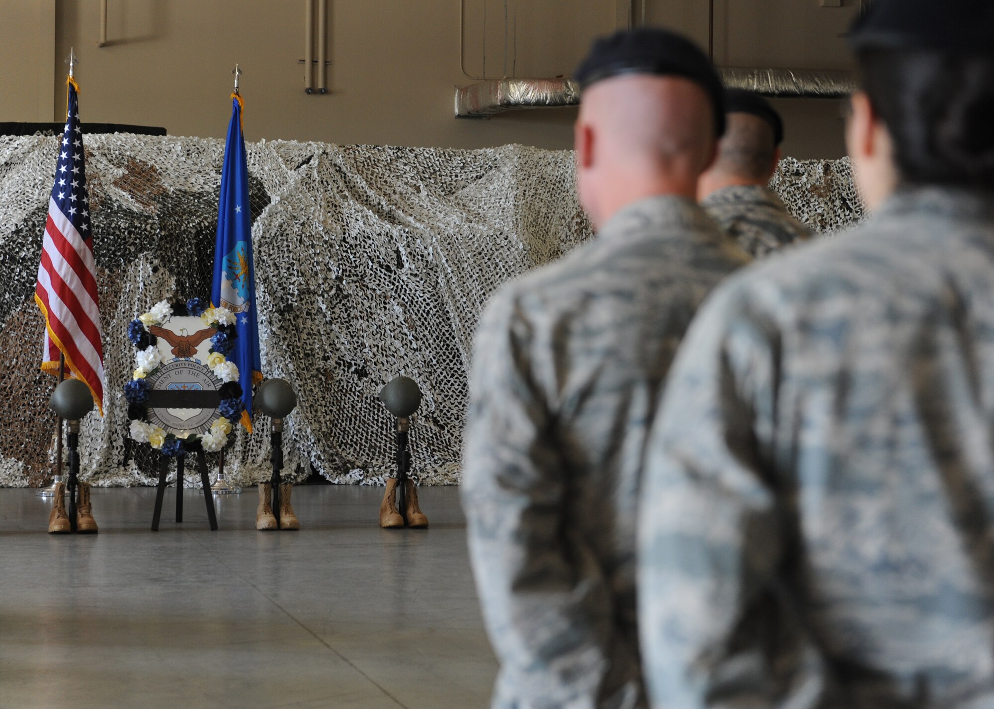 U.S. Air Force 19th Security Forces Squadron Defenders overlook a ceremonial wreath during a 2016 National Police Week closing ceremony May 13, 2016, at Little Rock Air Force Base, Ark. During the ceremony, the base honor guard fired three volleys and played taps to commemorate dead police officers. (U.S. Air Force photos by Senior Airman Mercedes Taylor) 

