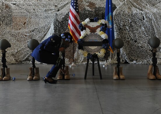 U.S. Air Force Senior Airman Desire White, 19th Security Forces visitor’s center clerk, places flowers on battlefield crosses during a 2016 National Police Week closing ceremony May 13, 2016, at Little Rock Air Force Base, Ark. The 19th SFS and local police agencies honored law enforcement officers and security forces service members who’ve died in the line of duty. (U.S. Air Force photos by Senior Airman Mercedes Taylor) 