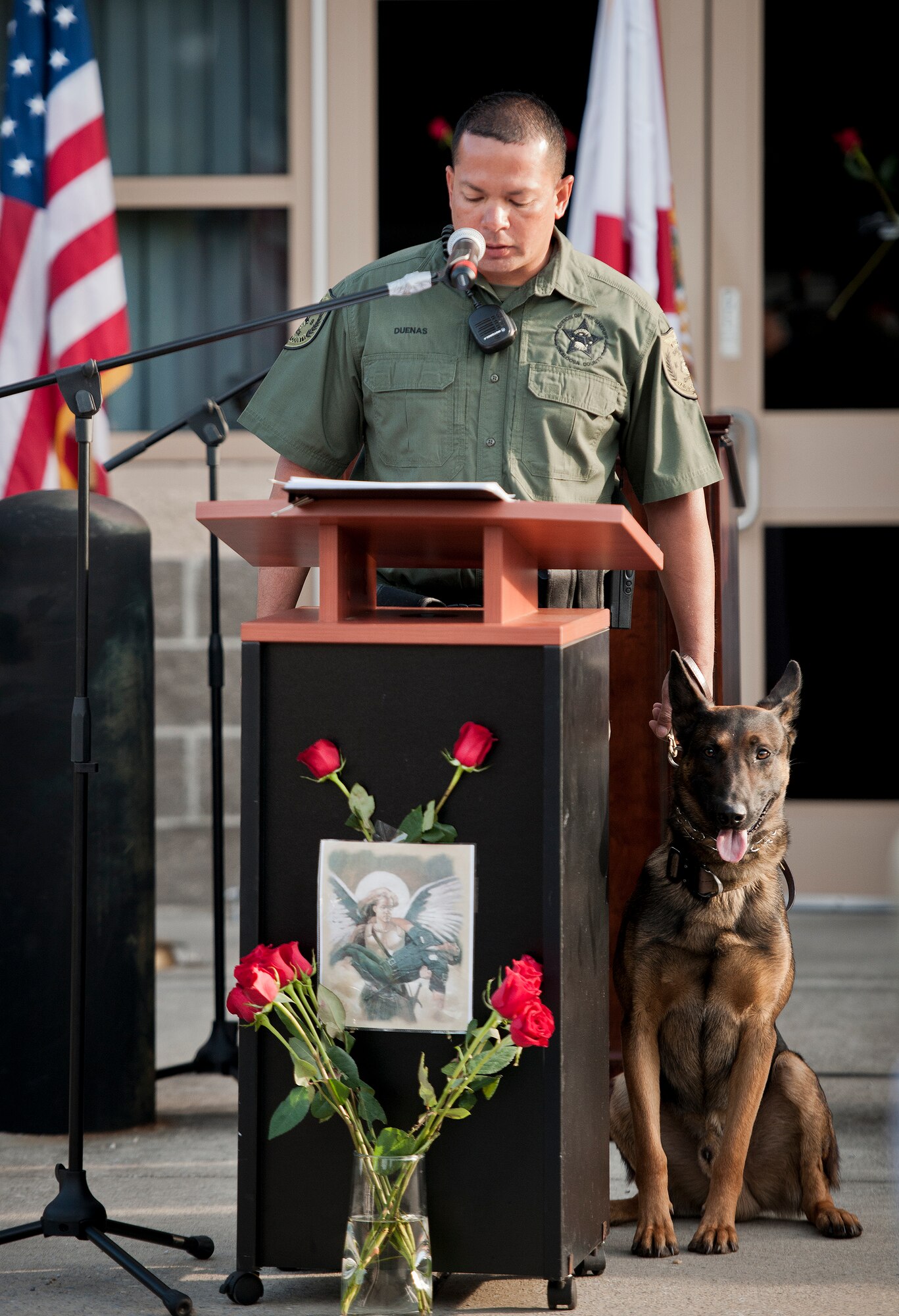 An Okaloosa County Sheriff’s Office dog handler reads off the names of fallen K-9s during the Peace Officers’ Memorial Ceremony May 16 in Fort Walton Beach, Fla.  The ceremony was to honor fallen police officers from the previous year by reading their names aloud.  Security forces Airmen from Eglin and Hurlburt Field attended and participated in the event.  The ceremony is one of many events taking place during National Police Week.  (U.S. Air Force photo/Samuel King Jr.)