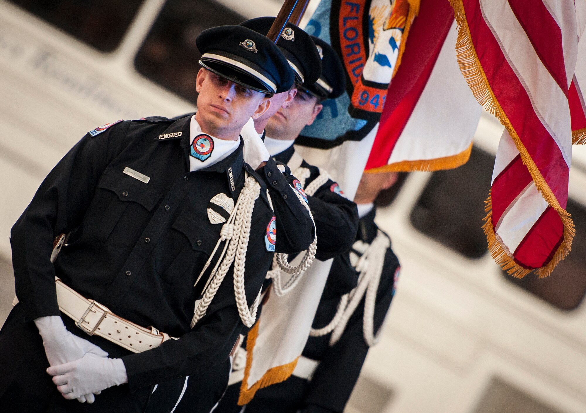 A police flag detail waits to bring in the colors during the during the Peace Officers’ Memorial Ceremony May 16 in Fort Walton Beach, Fla.  The ceremony was to honor fallen police officers from the previous year by reading their names aloud.  Security forces Airmen from Eglin and Hurlburt Field attended and participated in the event.  The ceremony is one of many events taking place during National Police Week.  (U.S. Air Force photo/Samuel King Jr.)