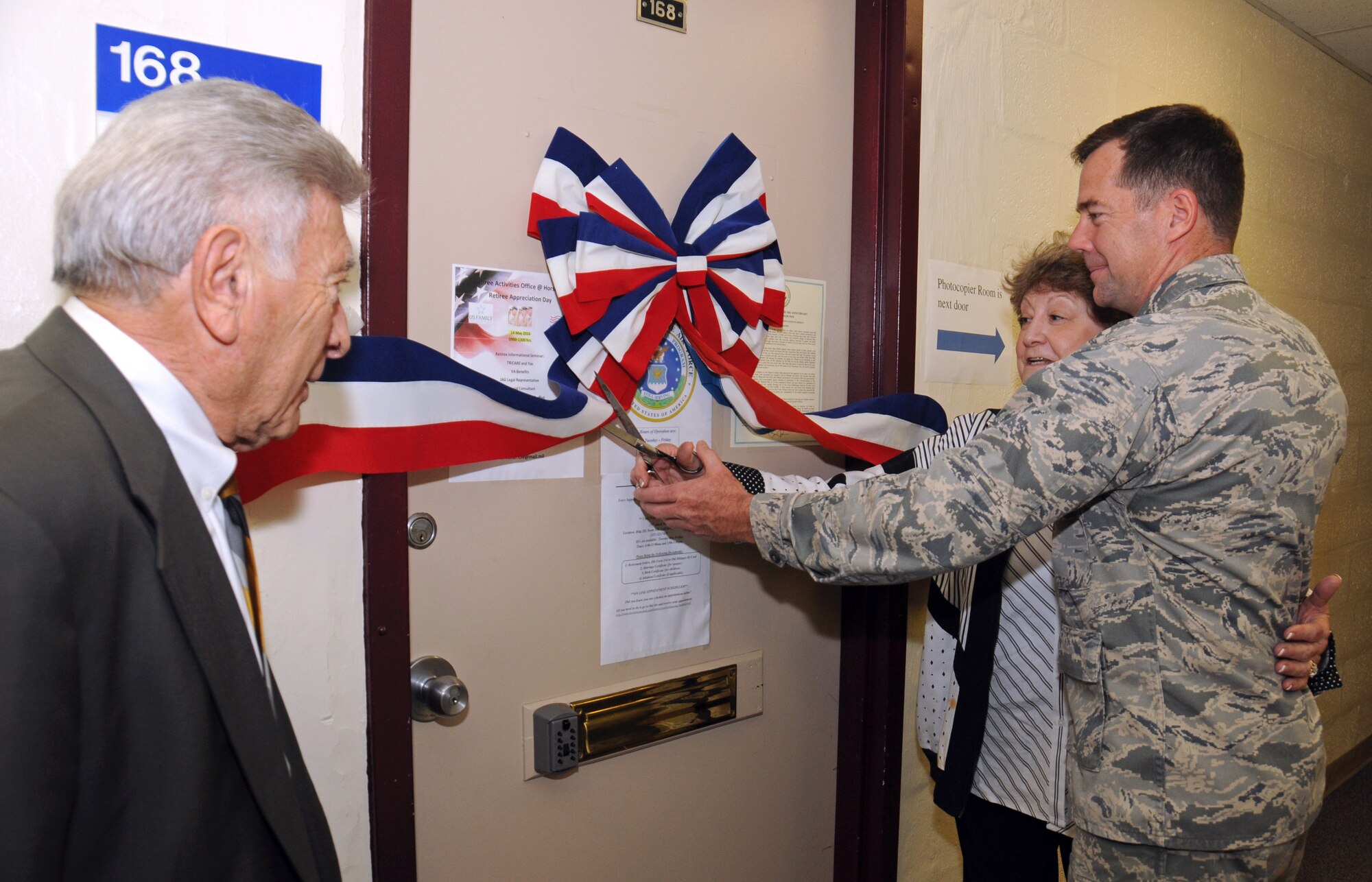 Col. William R. Griffin, Vice Commander of the 111th Attack Wing, and retired Chief Master Sgt. Jenny W. Pappas, Director of the 111th ATKW Retiree’s Activities Office, cut the ceremonial ribbon to the newly-founded 111th ATKW Retiree’s Activities Office at Horsham Air Guard Station, Pennsylvania, May 14, 2016. Attendees of the Retirees Appreciation Day held on base watched as the ribbon cutting ended the day-long event full of speakers, information and events for retired, recently retired and soon-to-be retired military personnel and spouses. (U.S. Air National Guard photo by Staff Sgt. Michael Shaffer)