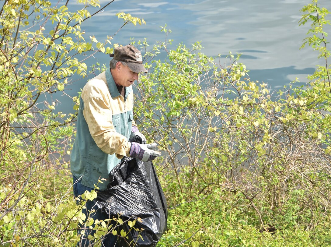 Senator John H. Eichelberger of Pennsylvania’s 30th Senatorial District collects trash along Raystown Lake's shoreline during the Raystown Lake Cleanup Day, May 7, 2016.  130 volunteers came together to collect debris from remote areas of Raystown Lake’s 110 miles of shoreline during the annual event.