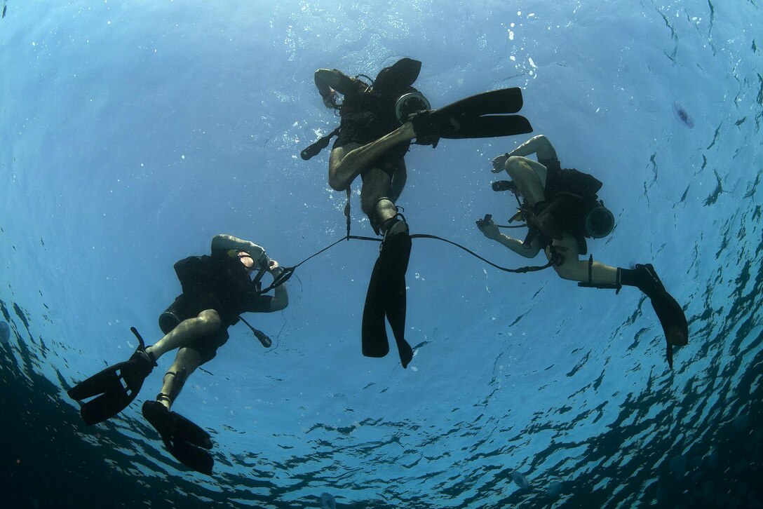 Navy divers head for the surface during an anti-terrorism force protection dive during exercise Eager Lion 2016 in the Gulf of Aqaba, Jordan, May 14, 2016. The divers are explosive ordnance disposal technicians assigned to commander, Task Group 56.1. Navy photo by Petty Officer 2nd Class Sean Furey