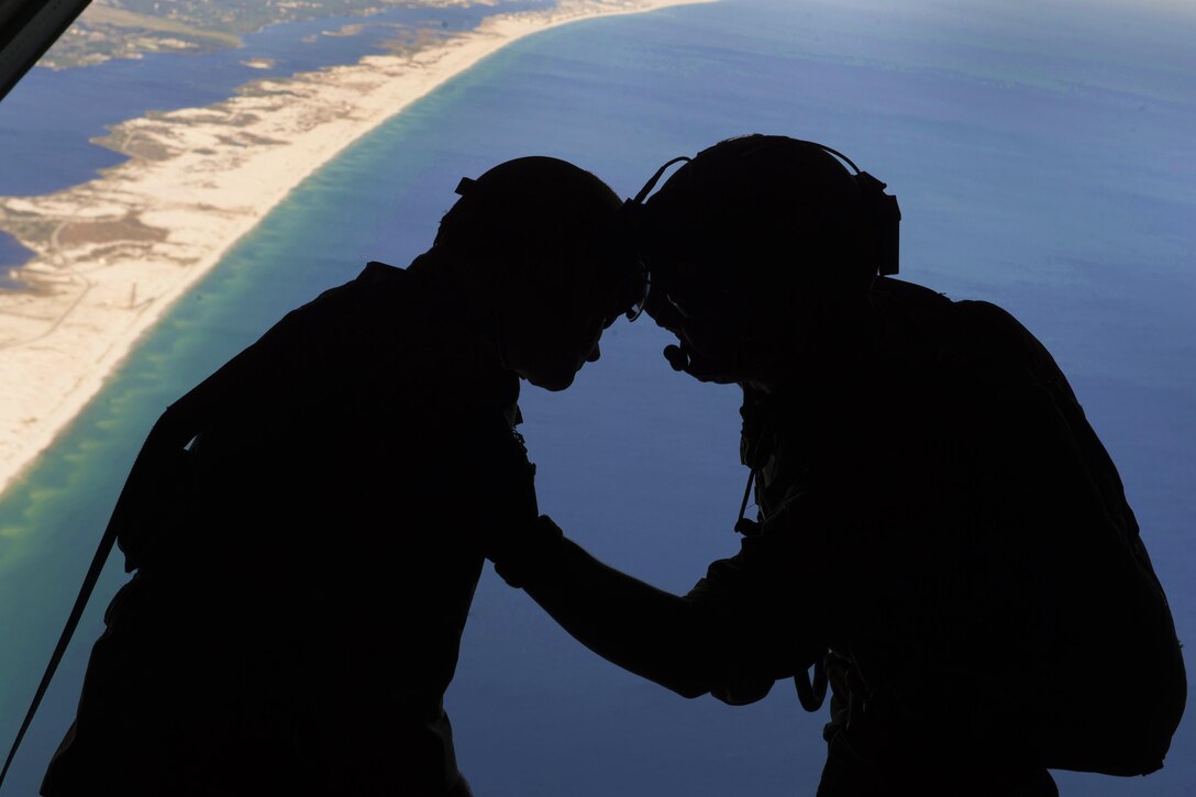 An Air Force loadmaster, left, talks to a jumpmaster on the ramp of an MC-130J Commando II aircraft during Emerald Warrior 16 at Hurlburt Field, Fla., May 4, 2016. Air Force photo by Staff Sgt. Paul Labbe