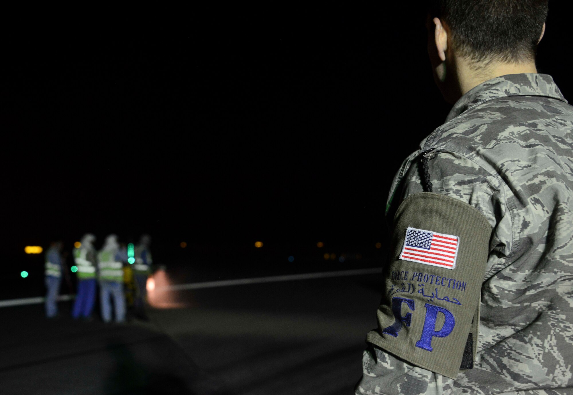 Staff Sgt. Will, 379th Civil Engineer Squadron force protection lead, provides force protection as contractors perform construction on the flight line May 11, 2016, at Al Udeid Air Base, Qatar. The force protection team ensures safety violations do not occur in controlled movement areas while contractors work around restricted assets or areas. (U.S. Air Force photo/Senior Airman Janelle Patiño/Released)