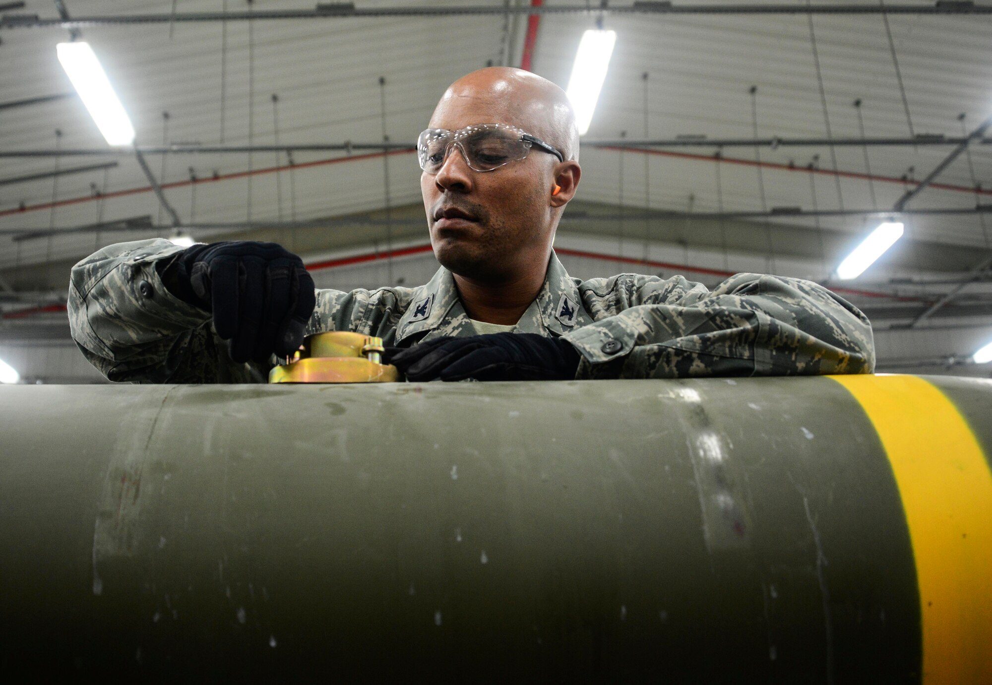 Col. Samuel White, 379th Air Expeditionary Wing vice commander, prepares the suspension lug sleeves on a guided bomb unit May 10, 2016, at Al Udeid Air Base, Qatar. Members of the 379th Expeditionary Maintenance Squadron Munitions Flight showed White and Chief Master Sgt. Thomas Good, 379th AEW command chief, what they do on a daily basis, such as building bombs that are used throughout the theater in the fight against Daesh. (U.S. Air Force photo/Senior Airman Janelle Patiño/Released)