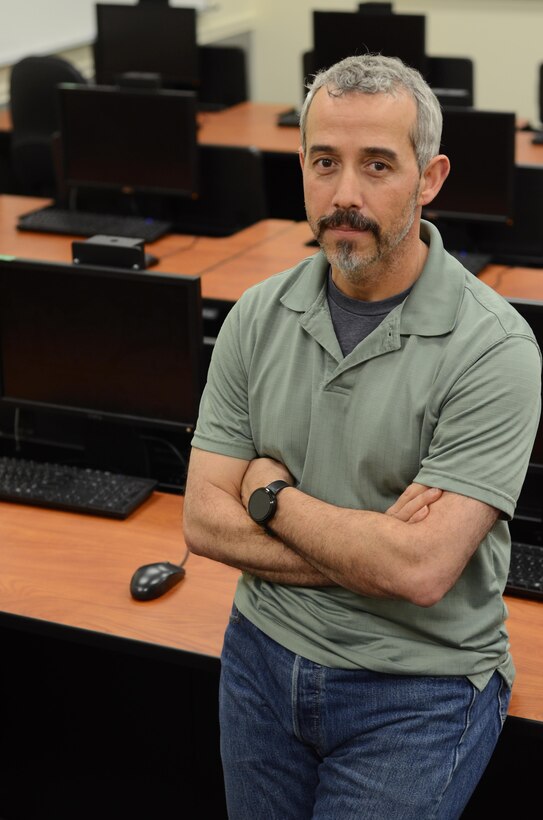 160505-N-HT014-208 FORT MEADE, Md. (May 5, 2016) – Robert Phelps, the information technology help desk operations manager at the Defense Information School on Fort Meade, stands by computer work stations that he and others, including service members awaiting training, installed in the school’s new wing. Phelps’ efforts led to his recognition as the DINFOS Civilian of the Quarter for the second quarter of fiscal 2016.