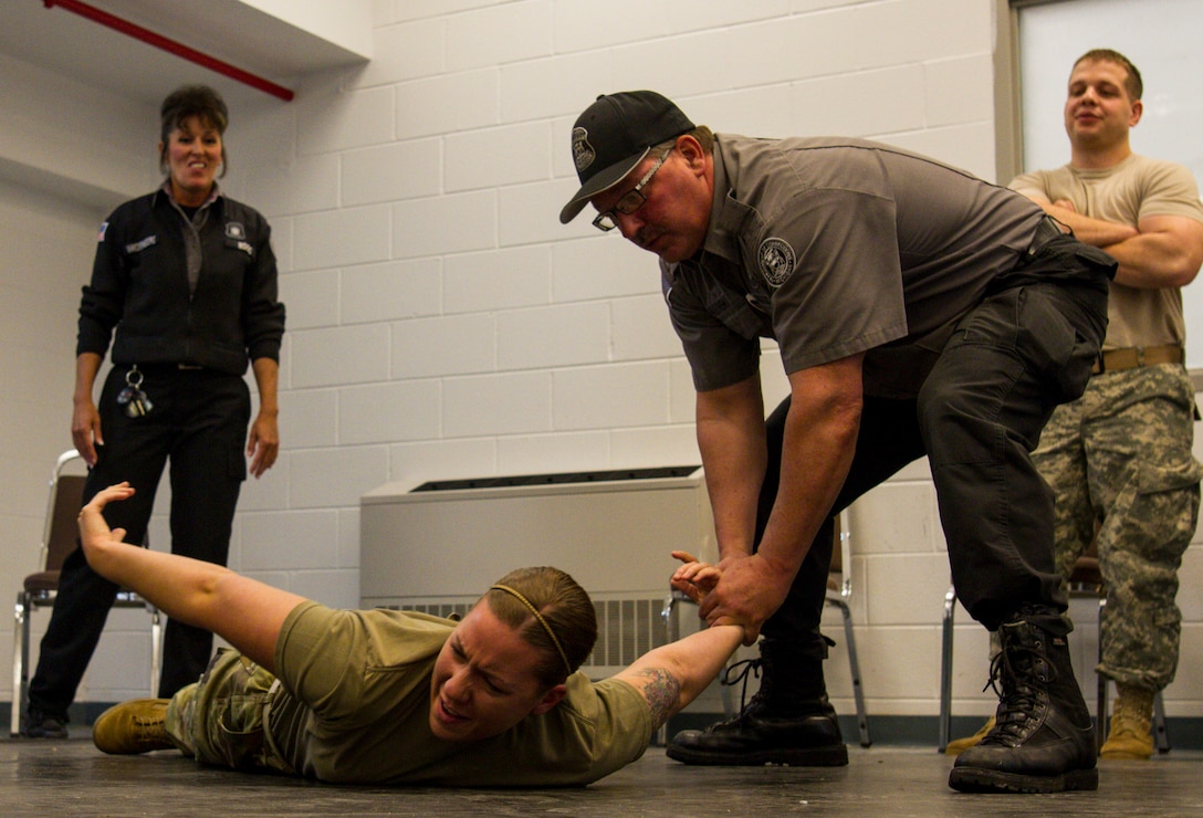 Spc. Macy Gretka, U.S. Army Reserve military police from Flint, Michigan, assigned to the 303rd MP Company is taught how to use the gooseneck tactic when restraining a detainee at the Charles Egeler Reception and Guidance Center in Jackson, Michigan, May 15.. The Soldiers with the company were taught inmate control by corrections officer trainers at the local facility. The training is in place to augment their detainee operations in preparation for an upcoming deployment to Guantanamo Bay, Cuba. (U.S. Army photo by Sgt. Audrey Hayes)