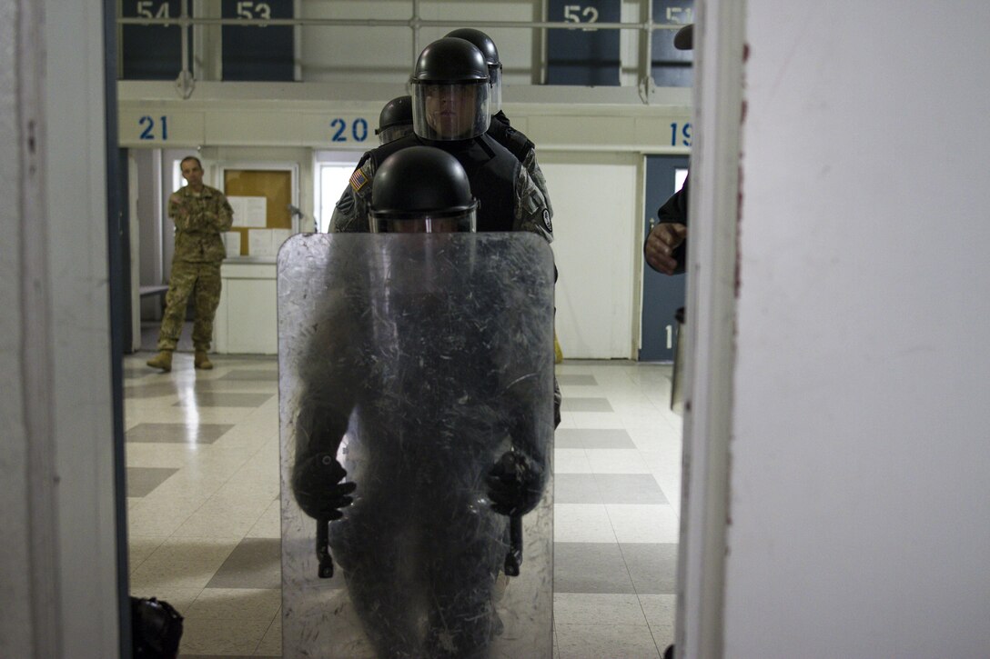 U.S. Army Reserve Soldiers assigned to the 303rd Military Police Company prepare to breach a prison cell during cell extraction training at the Charles Egeler Reception and Guidance Center in Jackson, Michigan, May 15. The corrections officer trainers at the local facility instructed the Soldiers on the proper extraction procedures. The training is in place to augment their detainee operations in preparation for an upcoming deployment to Guantanamo Bay, Cuba. (U.S. Army photo by Sgt. Audrey Hayes)