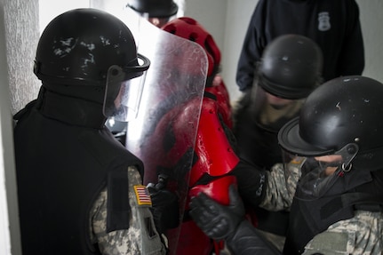 U.S. Army Reserve Soldiers assigned to the 303rd Military Police Company restrain a detainee during mock cell extraction training at the Charles Egeler Reception and Guidance Center in Jackson, Michigan, May 15. The corrections officer trainers at the local facility instructed the Soldiers on the proper extraction procedures. The training is in place to augment their detainee operations in preparation for an upcoming deployment to Guantanamo Bay, Cuba. (U.S. Army photo by Sgt. Audrey Hayes)