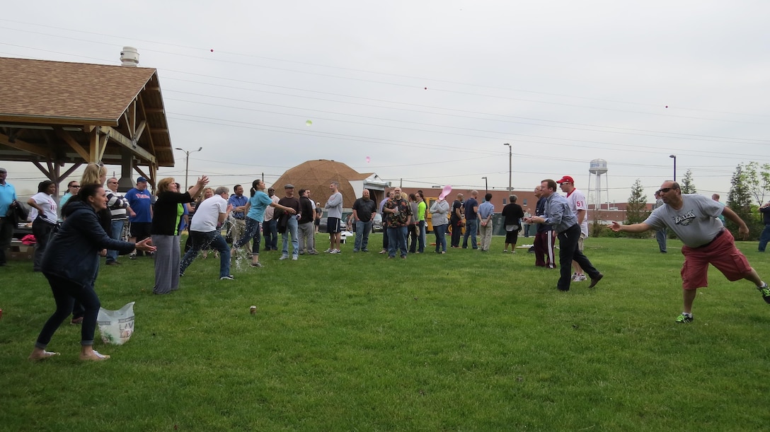Subsistence employees compete in a water balloon toss during a Spring Fling event May 11 at DLA Troop Support in Philadelphia.