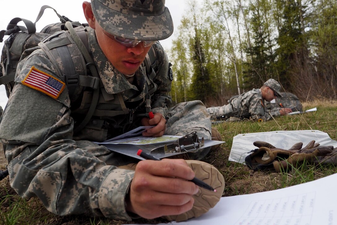 Army Spc. John Do plots points on a map during the land navigation portion of the Best Warrior Competition at Joint Base Elmendorf-Richardson, Alaska, May 3, 2016. Do is assigned to the 25th Infantry Division’s Company A, 725th Brigade Support Battalion Airborne, 4th Infantry Brigade Combat Team, Alaska. Air Force photo by Justin Connaher