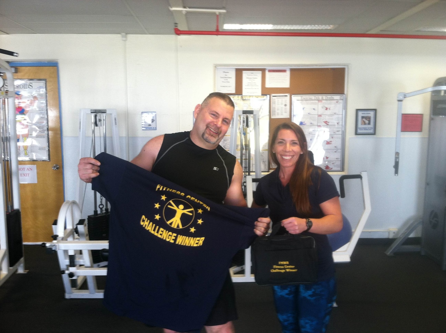 Steve Edmonson, DLA Distribution San Joaquin Maintenance Division Group deputy, is announced as the winner of the Fitness Center Challenge by trainer Jessica Sanchez.