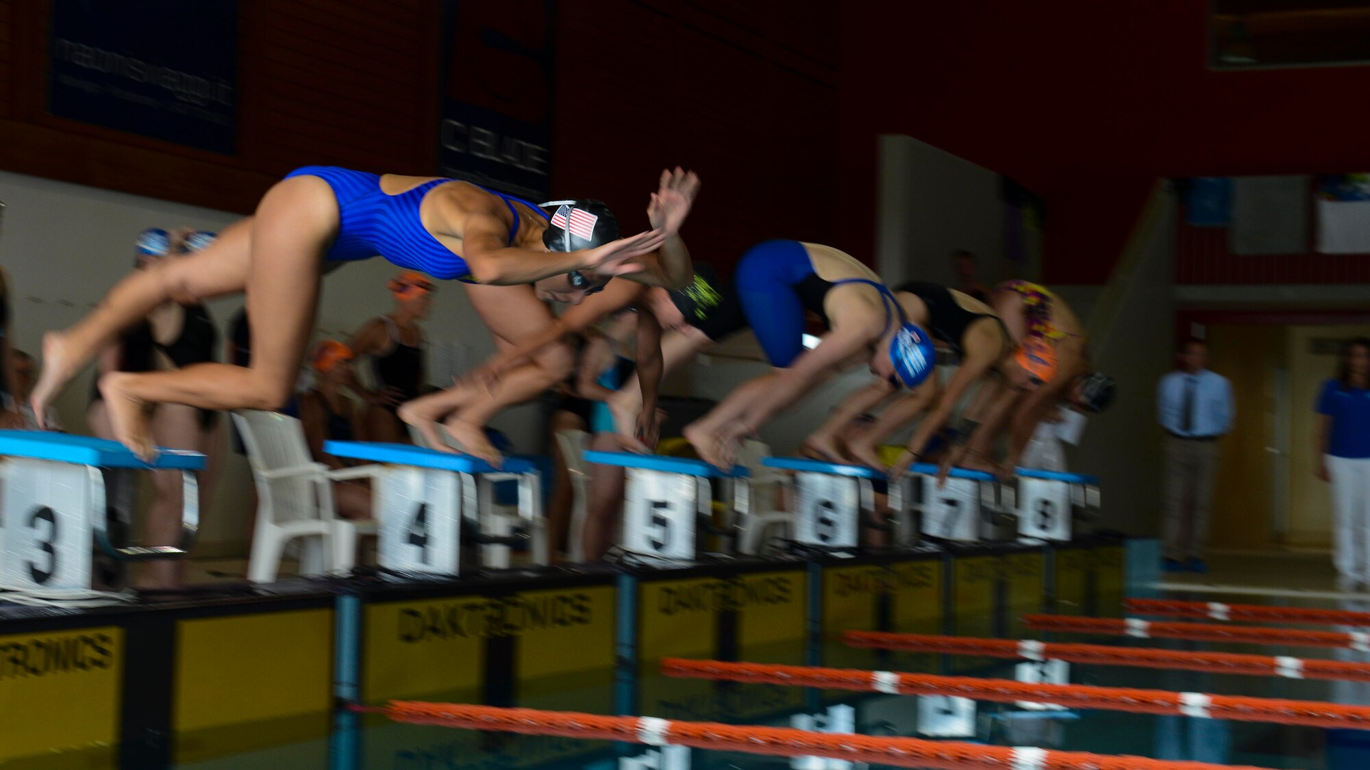 A U.S. Air Forces in Europe Airman dives into the pool during a 4-woman freestyle relay during the 2016 Headquarters Allied Air Command Swimming Championship, May 12, 2016, in Maniago, Italy. The 2016 HQ AIRCOM Swimming Championship brought together six nations from HQ AIRCOM in the spirit of friendly sporting competition. (U.S. Air Force photo by Senior Airman Austin Harvill/Released)