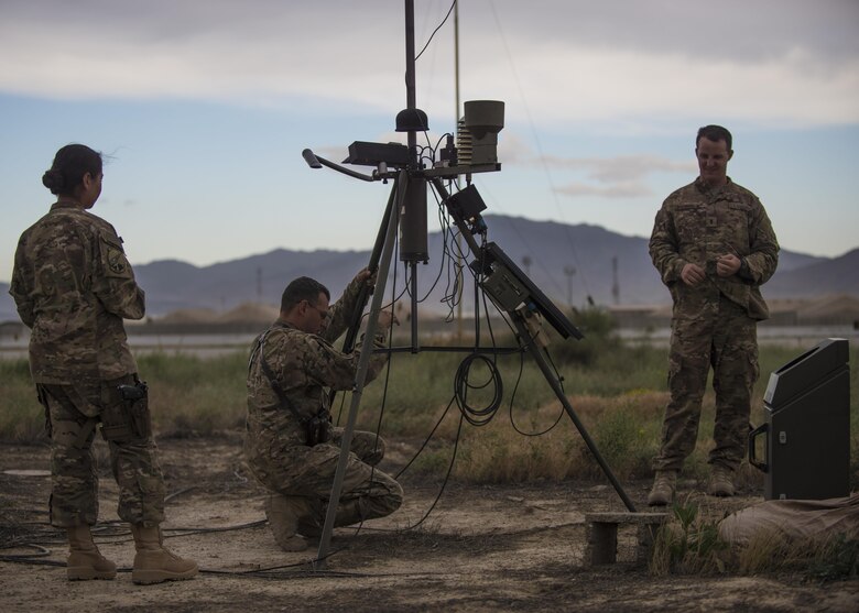 Members of the 455th Expeditionary Operations Support Squadron conduct an inspection of a Tactical Meteorological Observation System or TMQ-53 at Bagram Airfield, Afghanistan, May 16, 2016. The TMQ-53 collects weather data, that includes wind speed and direction, temperature, humidity, cloud height, precipitation and lightning. (U.S. Air Force photo by Senior Airman Justyn M. Freeman)