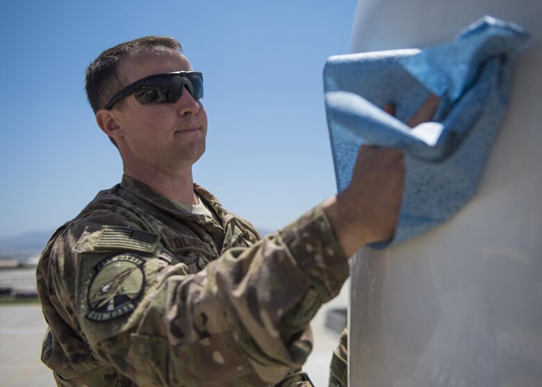 1st Lt. Justin D'olimpio, 455th Expeditionary Operations Support Squadron weather flight commander, cleans a portable Doppler radar (PDR-21) at Bagram Airfield, Afghanistan, May 16, 2016. Members of the 455th EOSS/OSW provide timely and accurate weather forecasts for aircrews, allowing flying units to plan and adjust mission requirements accordingly. (U.S. Air Force photo by Senior Airman Justyn M. Freeman)