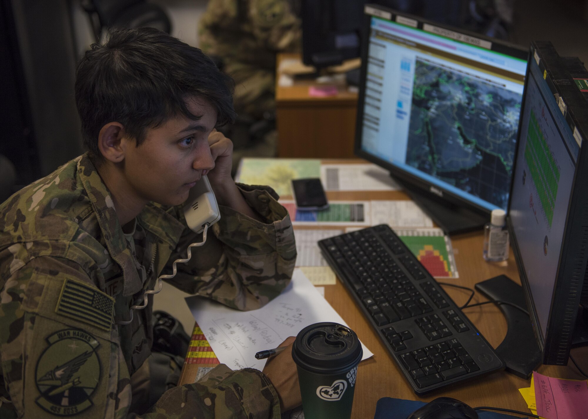 Airman 1st Class Angelena Legate, 455th Expeditionary Operations Support Squadron weather forecaster, updates a customer with the upcoming weather at Bagram Airfield, Afghanistan, May 16, 2016. Weather forecasters use satellite and radar imagery, computer generated graphics, and weather communication equipment and instruments to analyze atmospheric and space data information. (U.S. Air Force photo by Senior Airman Justyn M. Freeman)