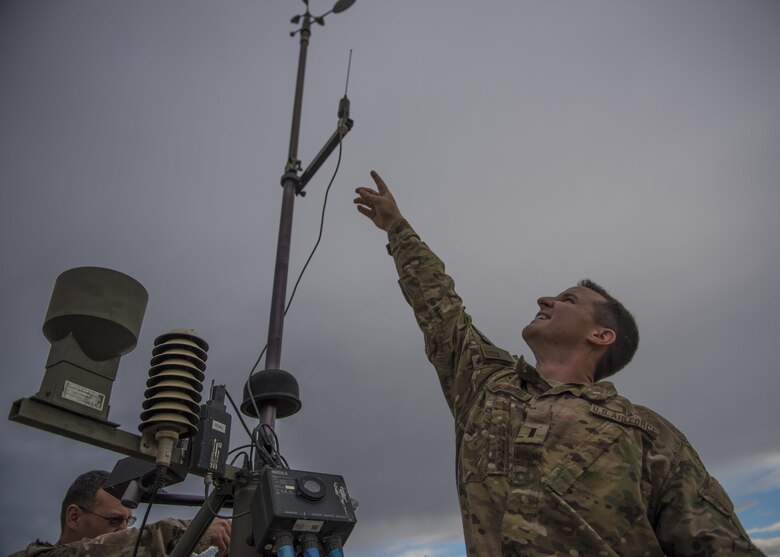 1st Lt. Justin D'olimpio, 455th Expeditionary Operations Support Squadron weather flight commander, points at a Tactical Meteorological Observation System or TMQ-53 at Bagram Airfield, Afghanistan, May 16, 2016. Members of the 455th EOSS/OSW provide timely and accurate weather forecasts for aircrews, allowing flying units to plan and adjust mission requirements accordingly. (U.S. Air Force photo by Senior Airman Justyn M. Freeman)