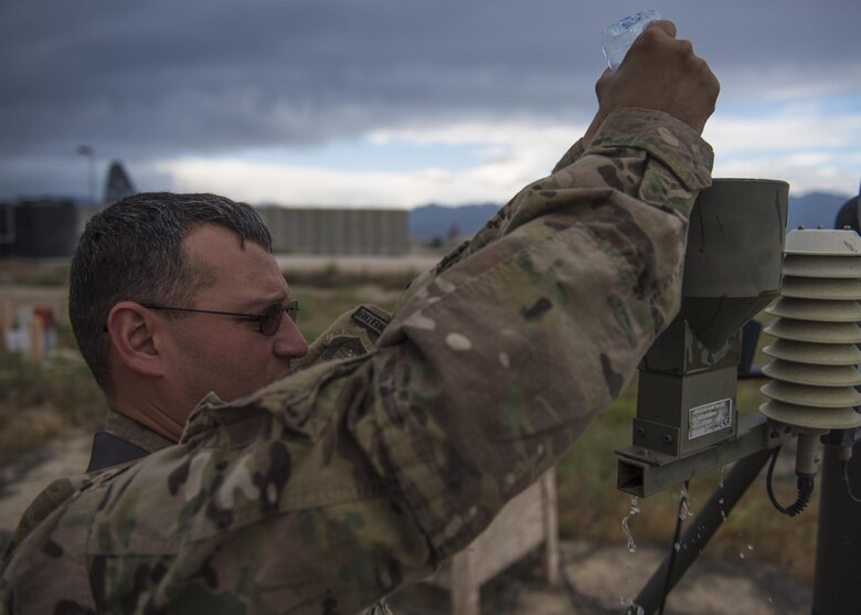 Technical Sgt. Heinz Disch, 455th Expeditionary Operations Support Squadron weather forecaster, cleans the precipitation catcher on a Tactical Meteorological Observation System or TMQ-53 at Bagram Airfield, Afghanistan, May 16, 2016. The TMQ-53 collects weather data, including wind speed and direction, temperature, humidity, cloud height, precipitation and lightning. (U.S. Air Force photo by Senior Airman Justyn M. Freeman)