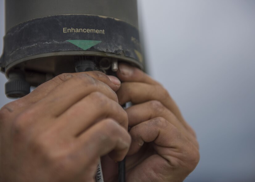 Technical Sgt. Heinz Disch, 455th Expeditionary Operations Support Squadron weather forecaster, plugs a wire back into a Tactical Meteorological Observation System or TMQ-53 at Bagram Airfield, Afghanistan, May 16, 2016. The TMQ-53 collects weather data, including wind speed and direction, temperature, humidity, cloud height, precipitation and lightning. (U.S. Air Force photo by Senior Airman Justyn M. Freeman)